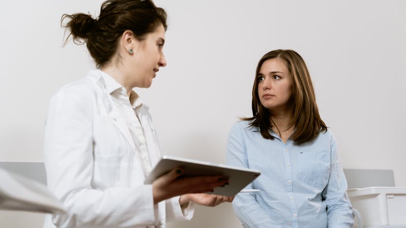 Doctor consulting with patient about health goals in clinic