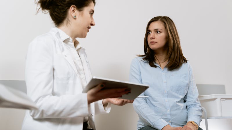 Chiropractor reviewing spinal imaging with patient