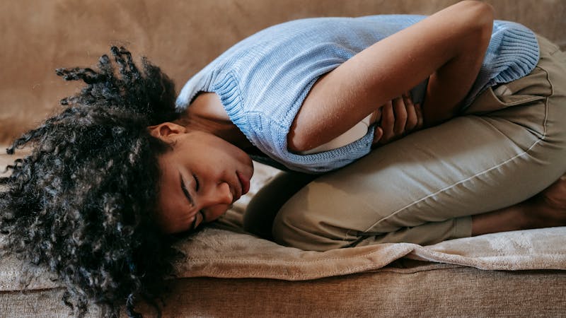 Woman experiencing abdominal discomfort from gut dysbiosis