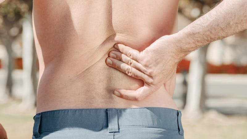 Person touching their back