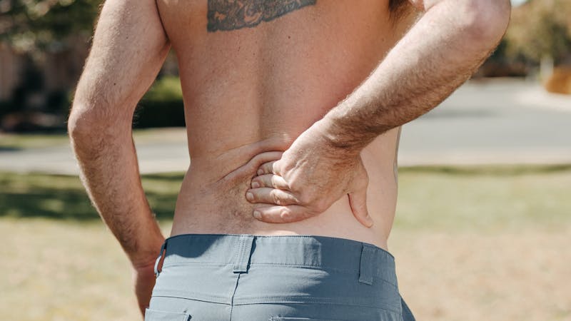 Person experiencing lower back pain from sciatica
