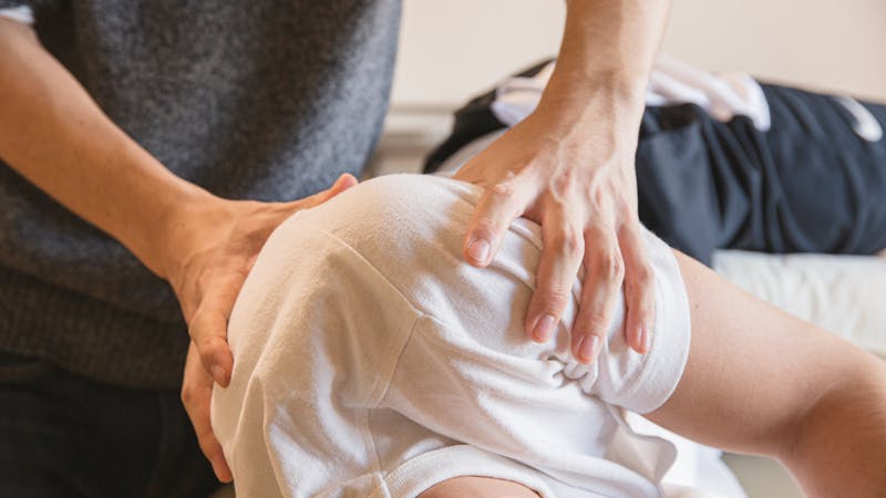 Shockwave therapy device applied to patient elbow