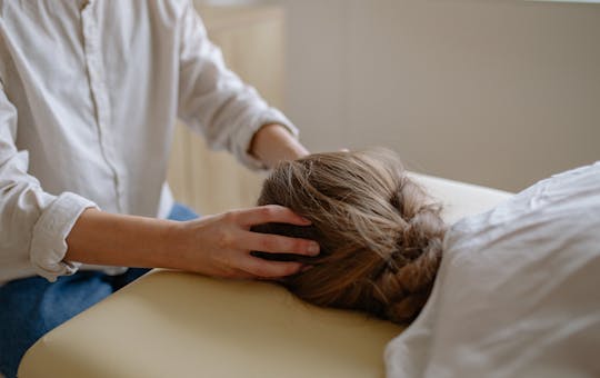 Patient receiving spinal decompression treatment on chiropractic table